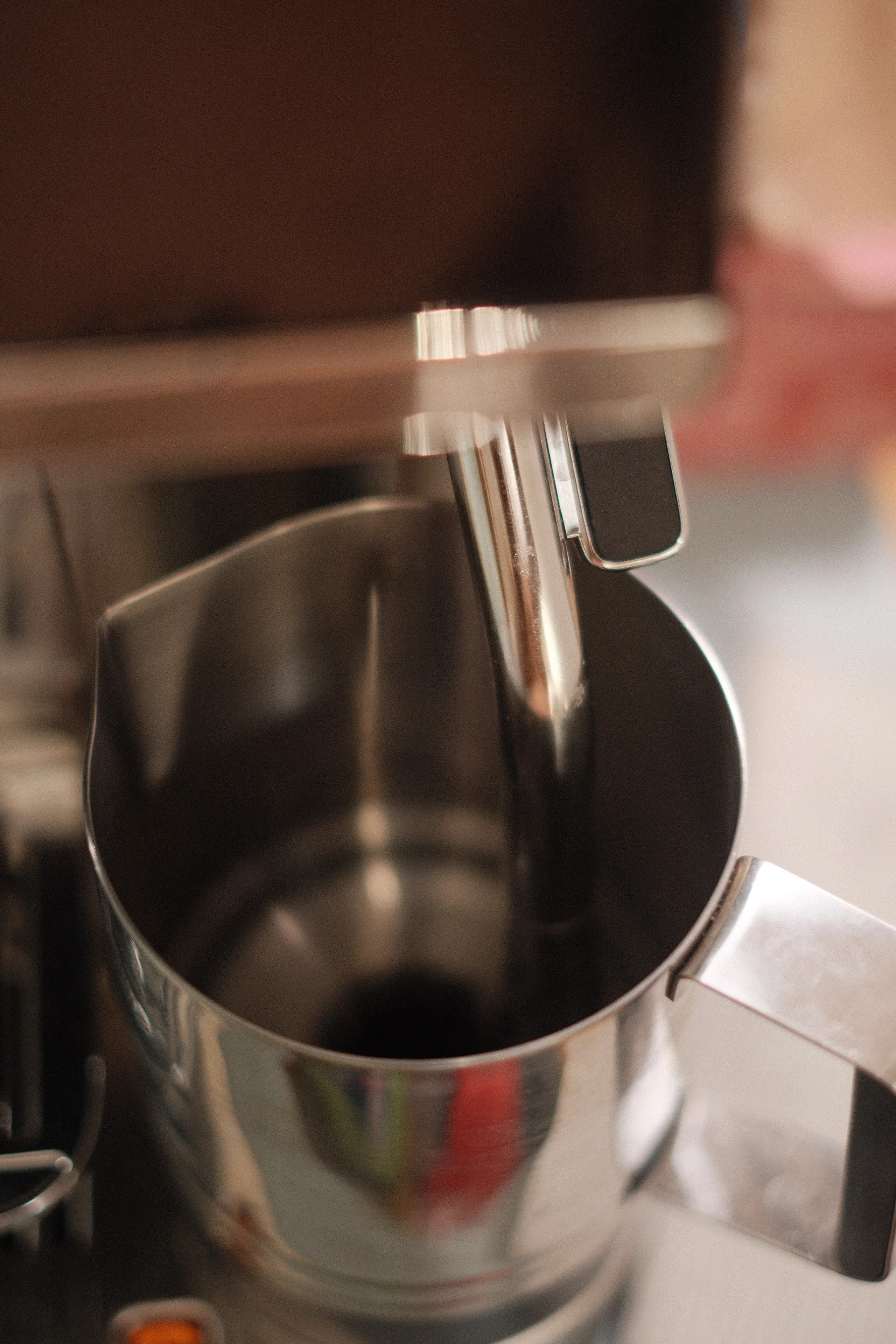 The stainless milk pitcher and steam wand
